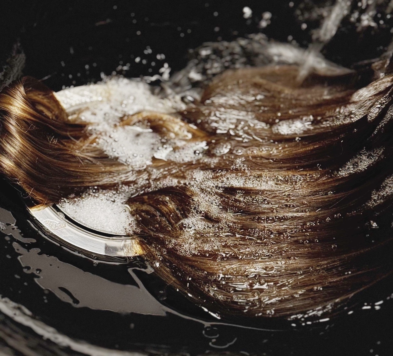 hair bein washed in a salon bowl