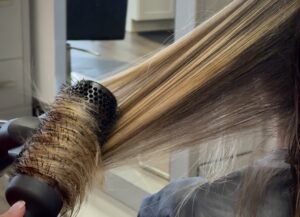 hair being blow dried with a round brush
